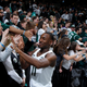 Michigan State basketball players Tum Tum Nairn (11) and Cassius Winston (5) greet fans after a 2018 win over Purdue,